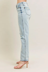 Light blue jeans with a distressed design on a beige background