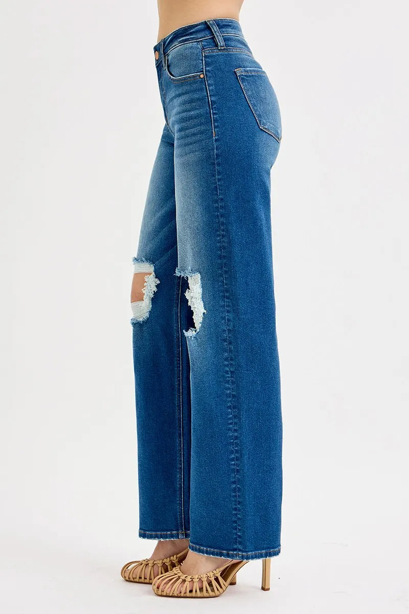 Blue jeans with a distressed design on a white background