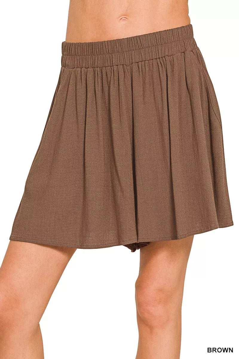 Brown skirt worn by a person on a white background