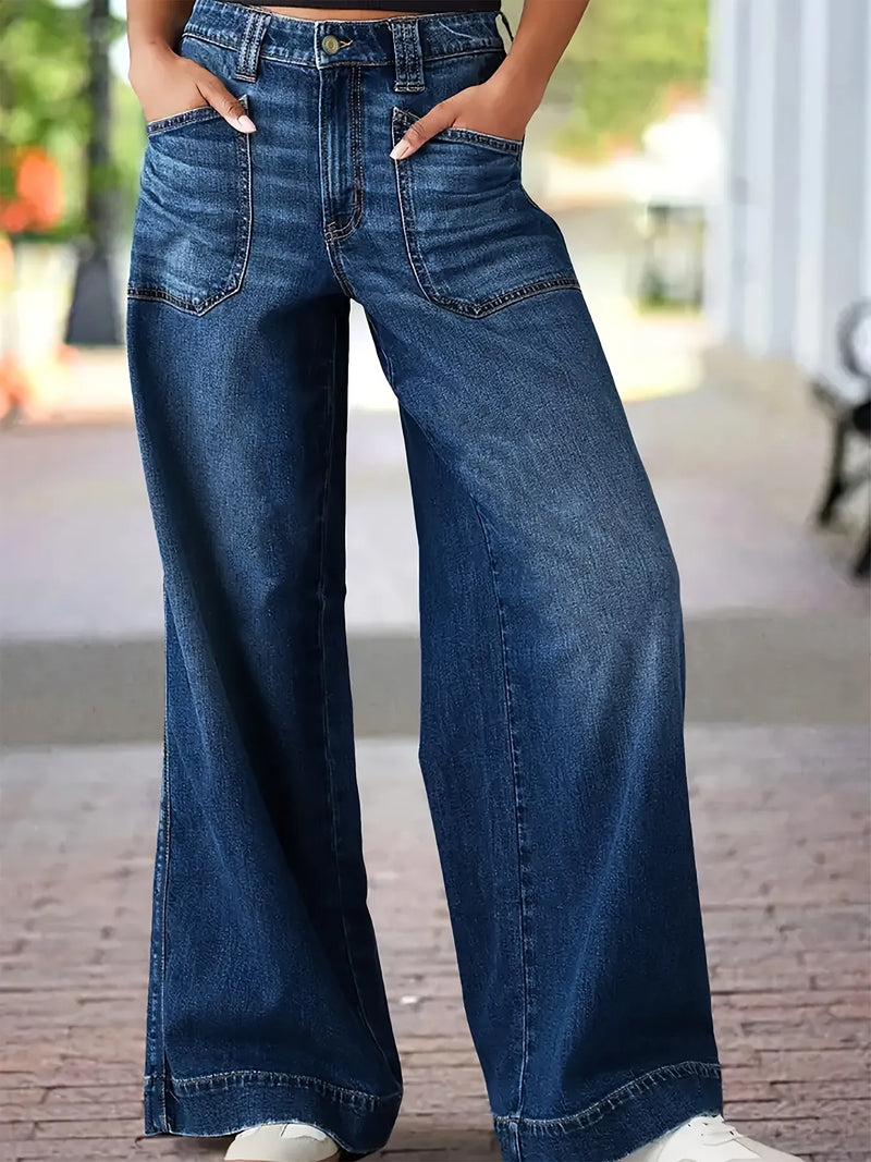 Wide-leg jeans worn by a person on a blurred indoor background
