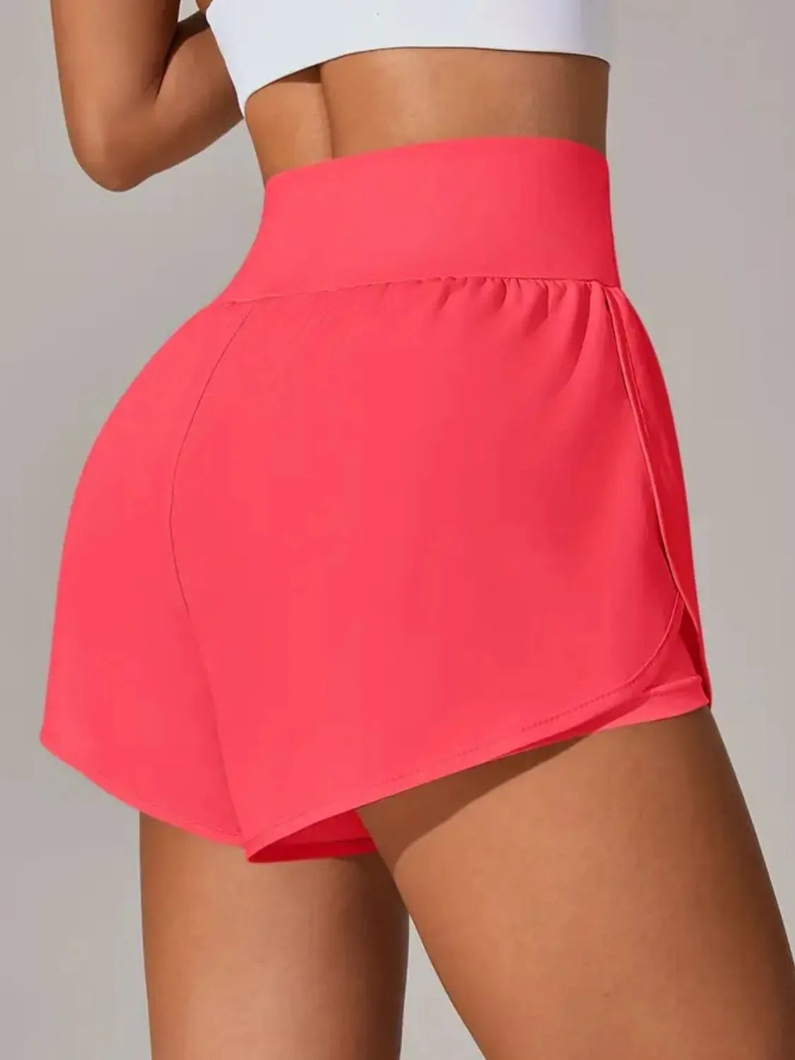 Person wearing a bright pink skirt on a plain background