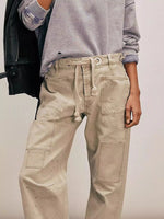 Close up view of beige jeans