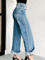 Light blue jeans worn by a person on a neutral background