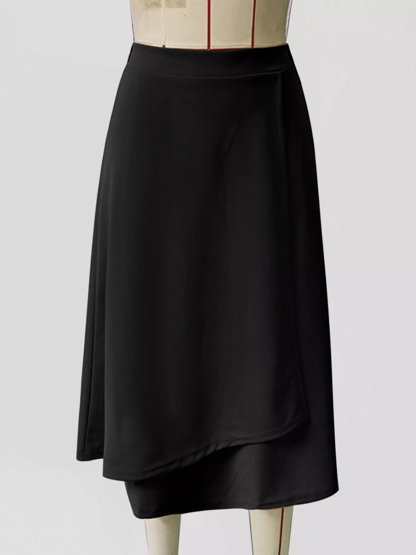 Black skirt on a mannequin against a white background