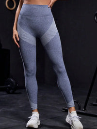 Person wearing blue athletic leggings on a black background