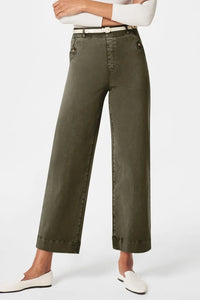 Person wearing olive green pants on a white background