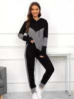 Woman wearing a black and white checkered outfit with a white background
