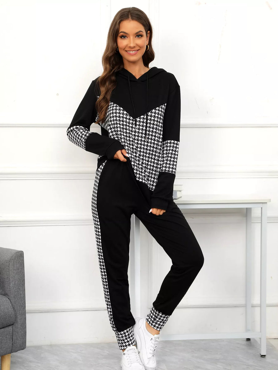 Woman wearing a black and white checkered outfit with a white background