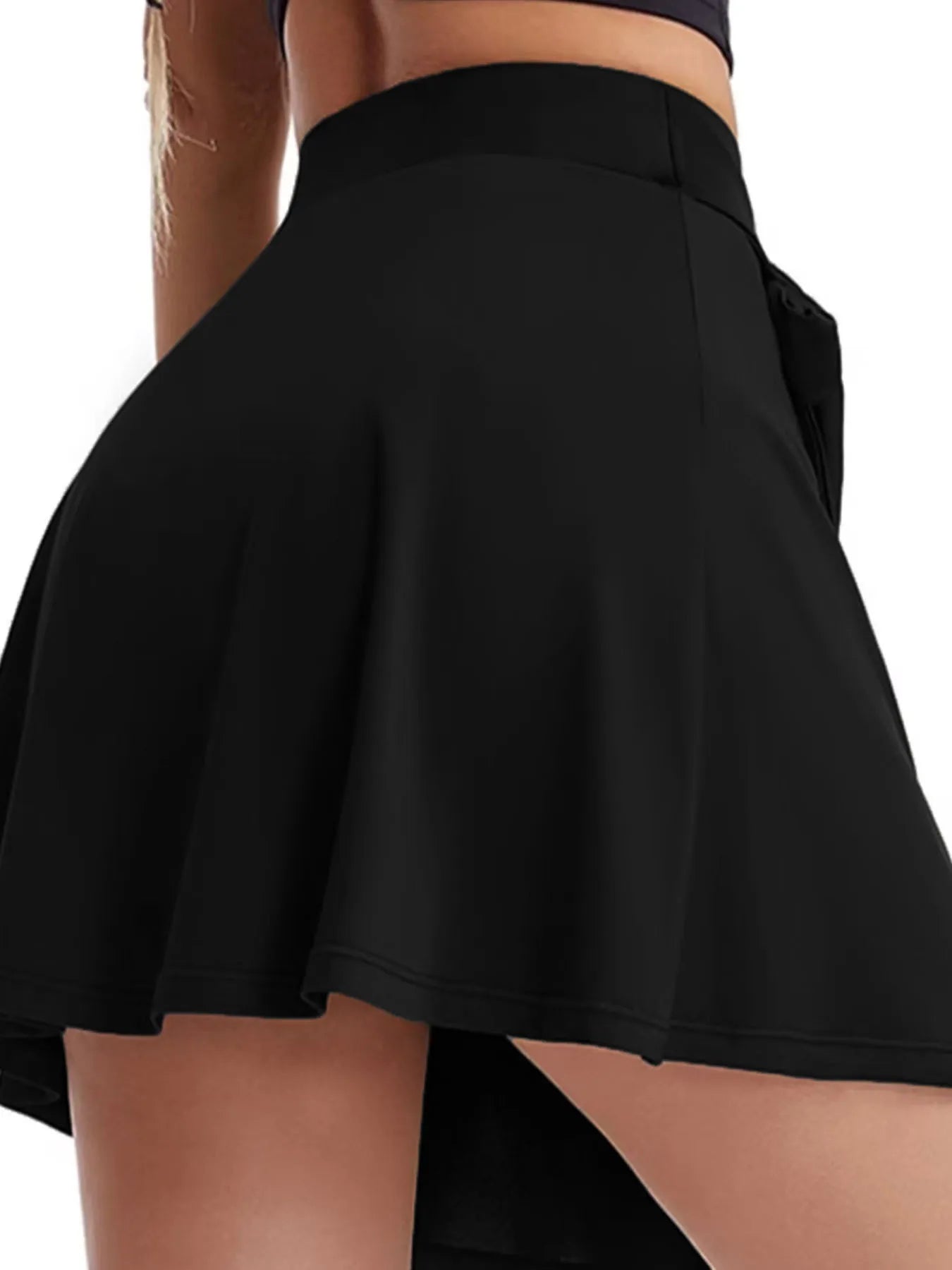 Black skirt worn by a person on a white background