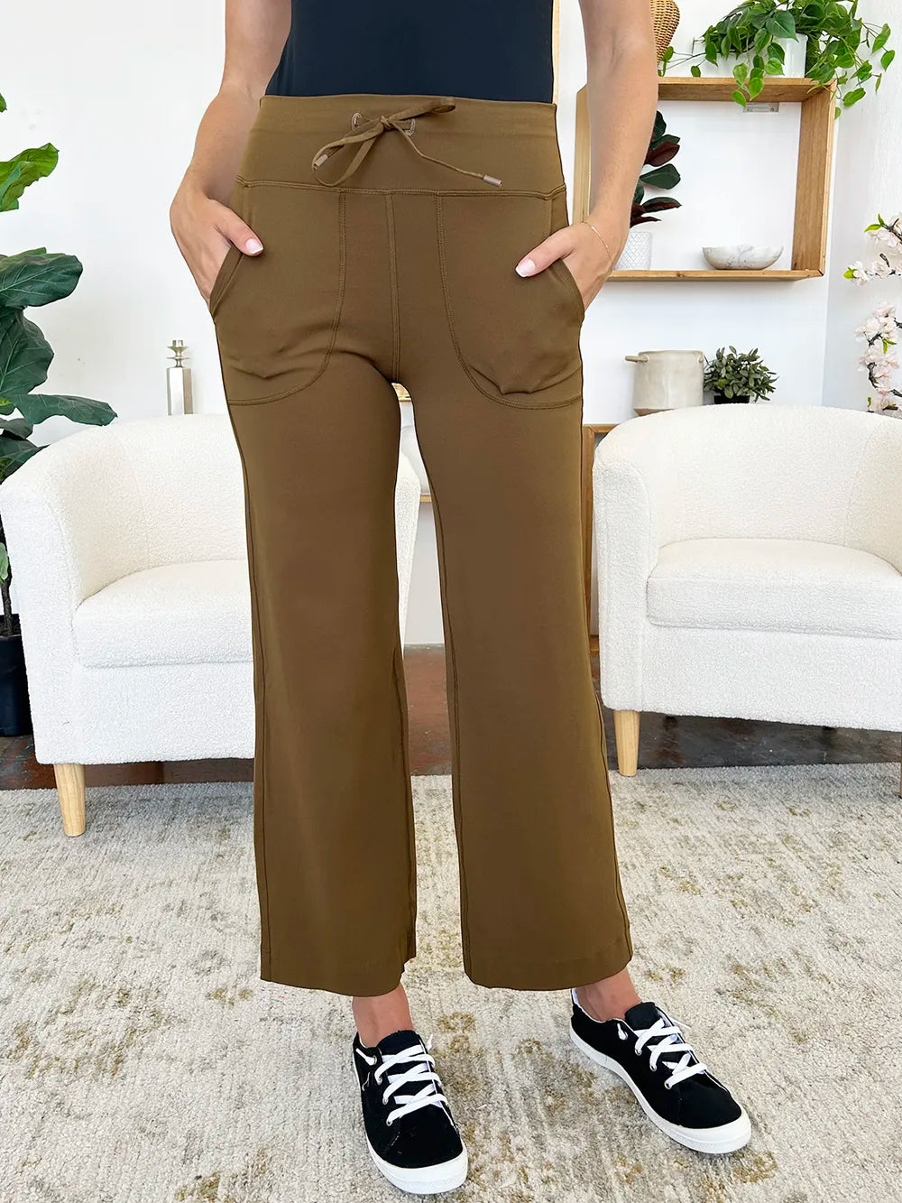 Person wearing brown pants in a living room setting