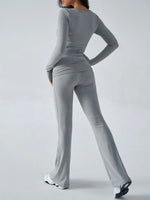 Person wearing a gray long-sleeve top and pants set on a white background