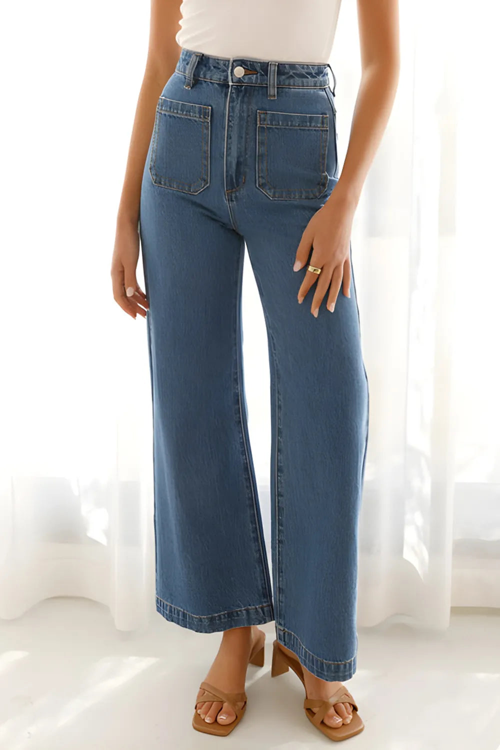 Person wearing blue jeans with a white background