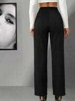 Person wearing black wide-leg pants with a white cropped top against a gray background.