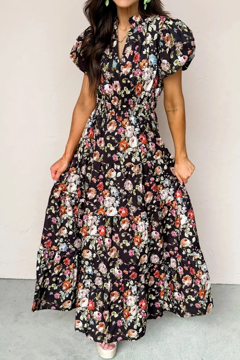 Woman wearing a floral dress with a plain background