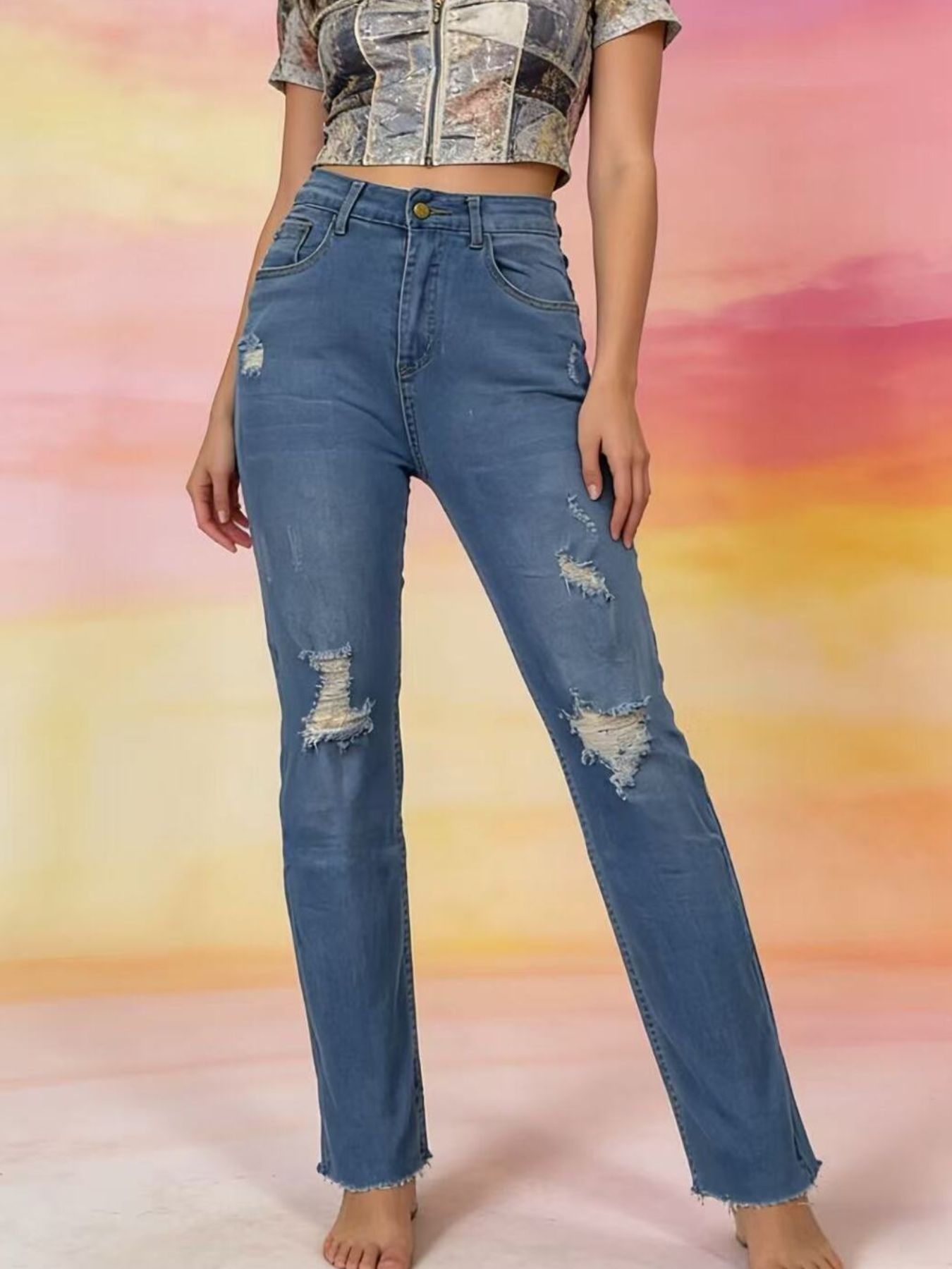 Person wearing blue jeans with a colorful abstract background