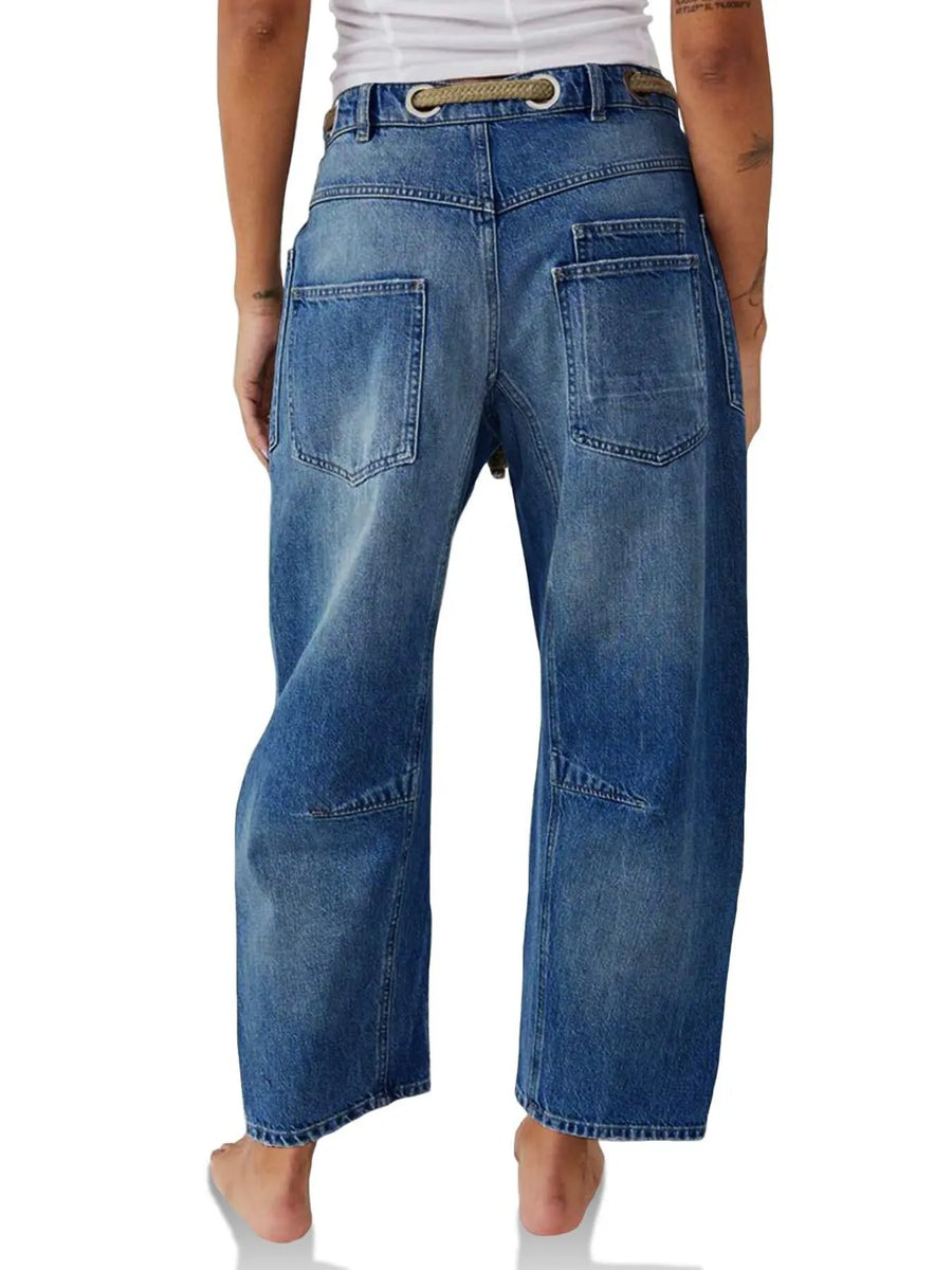 Blue jeans worn by a person on a white background
