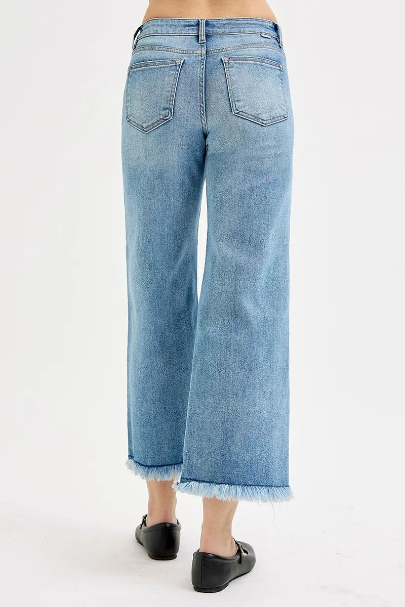 Light blue jeans worn by a person on a white background