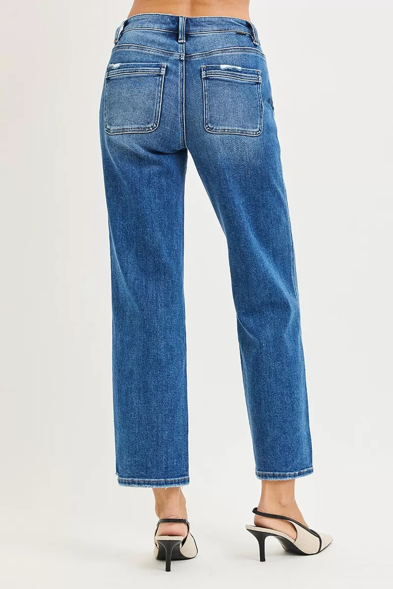 Blue jeans worn by a person on a white background