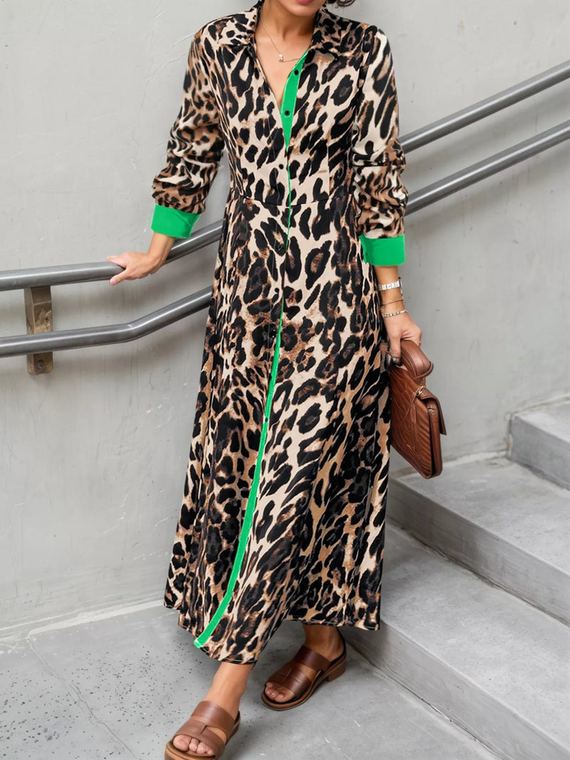 Person wearing a leopard print dress with green accents, standing on stairs.