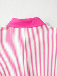 Close-up of a pink and white striped shirt with a pink collar on a light gray background