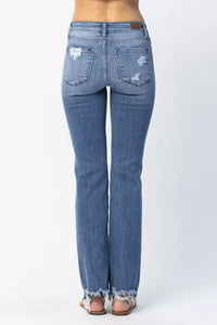 Blue jeans with distressed details on a white background
