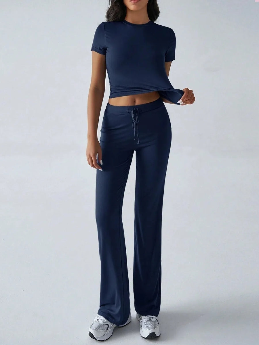 Person wearing a navy blue athletic outfit on a white background