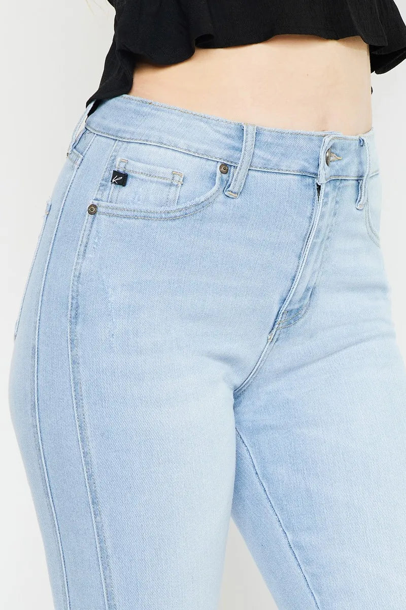 Light blue jeans worn by a person on a white background
