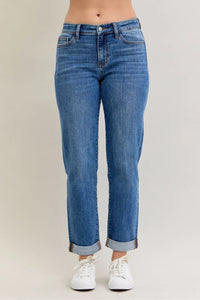 Blue jeans worn by a person on a plain background