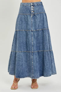 Long denim skirt on a plain background