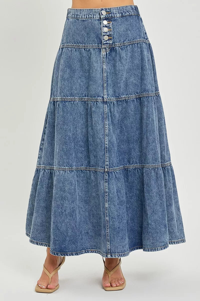 Long denim skirt on a plain background