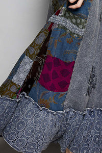 Close-up of a patchwork garment with various patterns and colors.