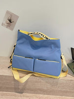 Blue bag with yellow straps on a wooden surface