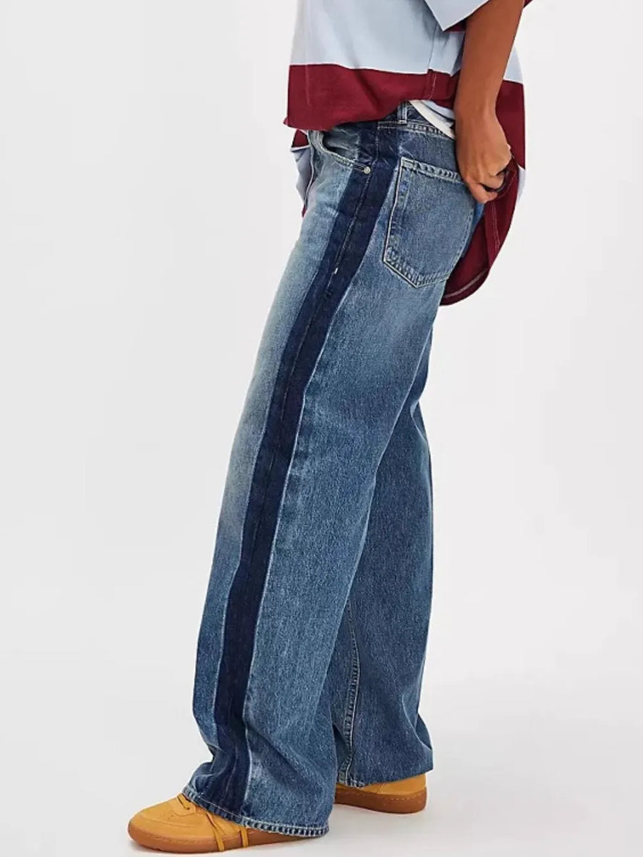 Person wearing blue jeans with a white background