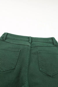 Green pants with back pocket detail on a white background