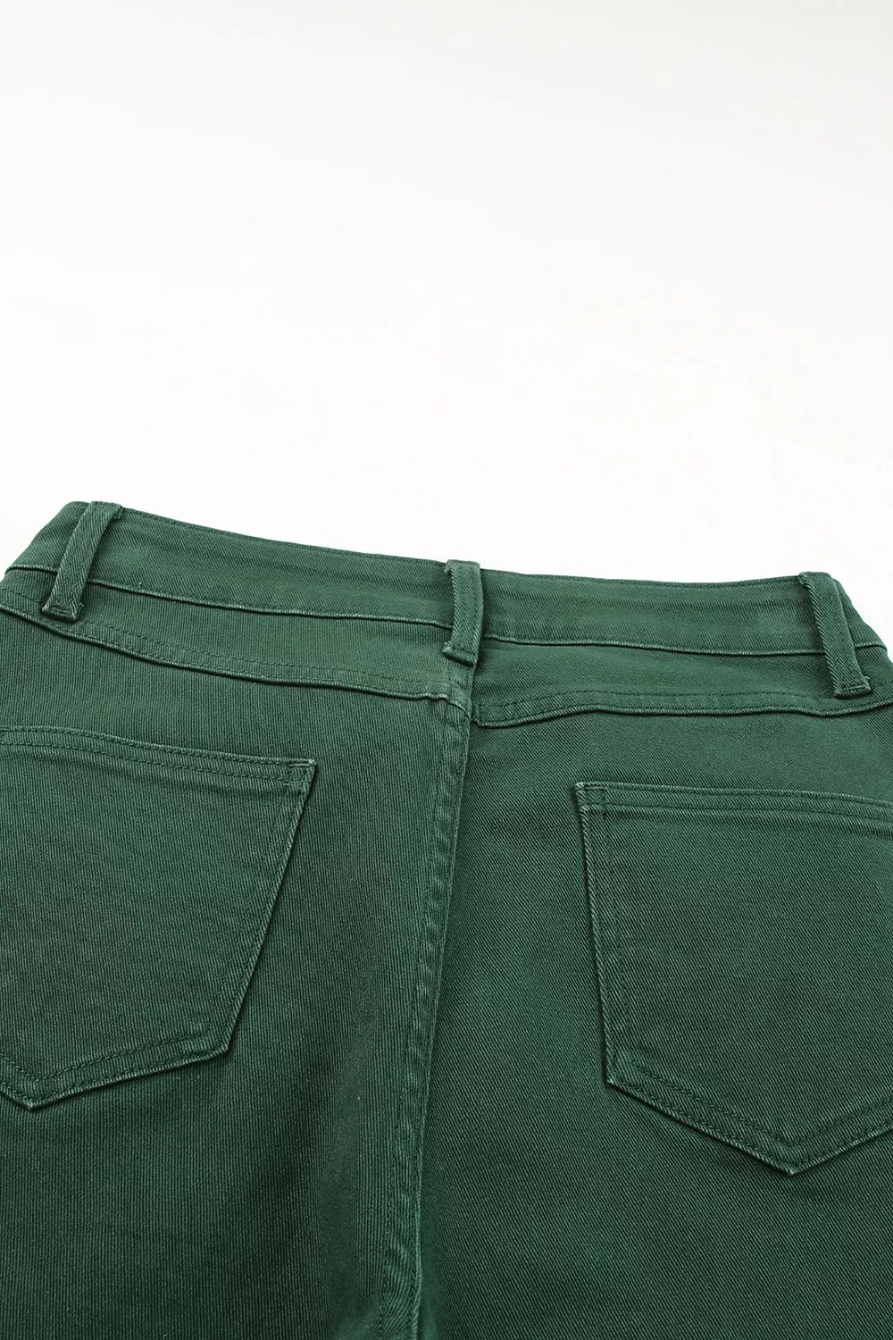 Green pants with back pocket detail on a white background