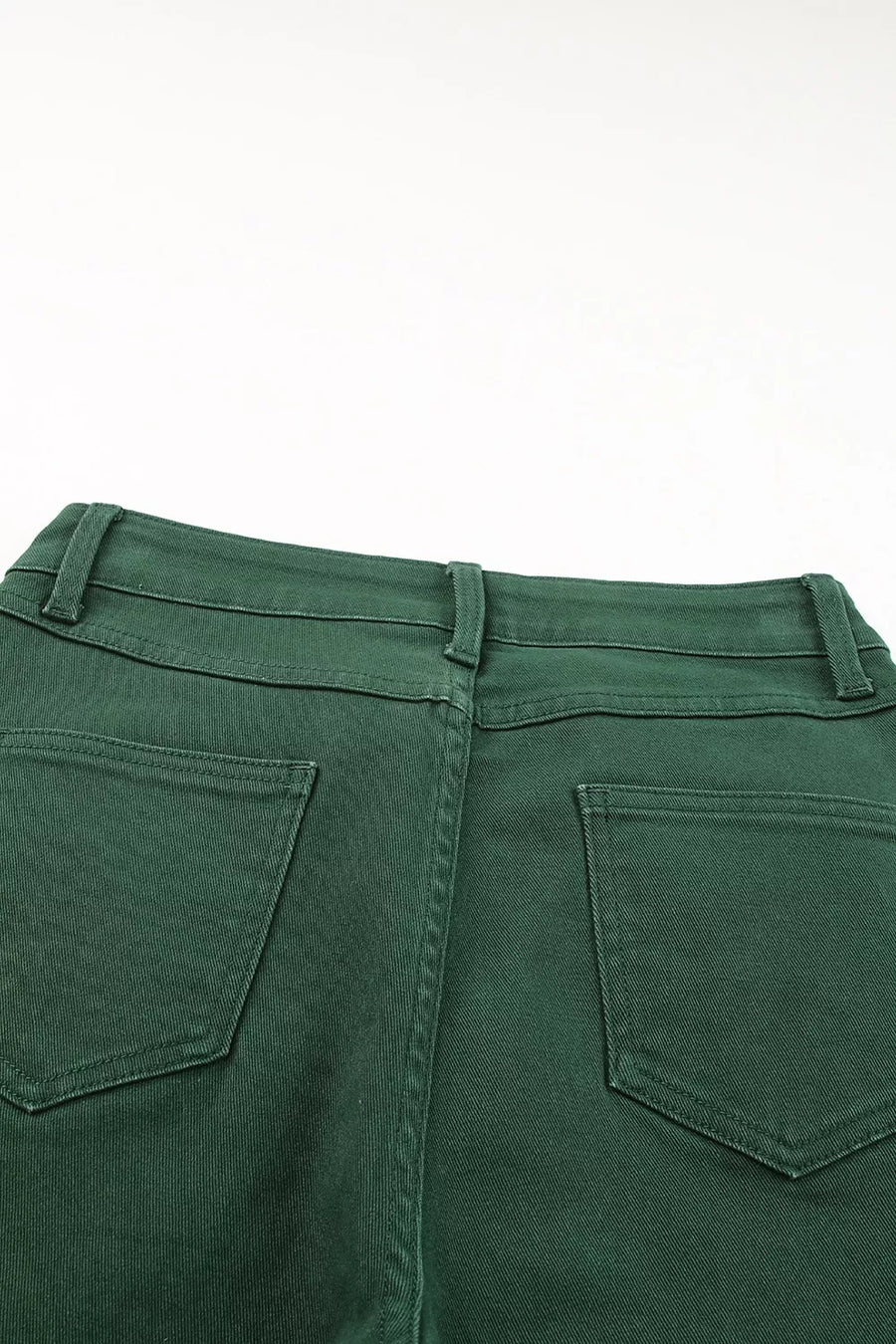 Green pants with back pocket detail on a white background