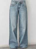 Light blue wide-leg denim jeans with a high waist and elastic waistband, shown against a plain off-white wall.