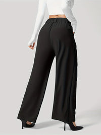 Black wide-leg pants worn by a person on a gray background