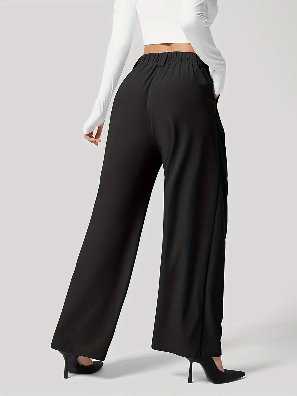 Black wide-leg pants worn by a person on a gray background