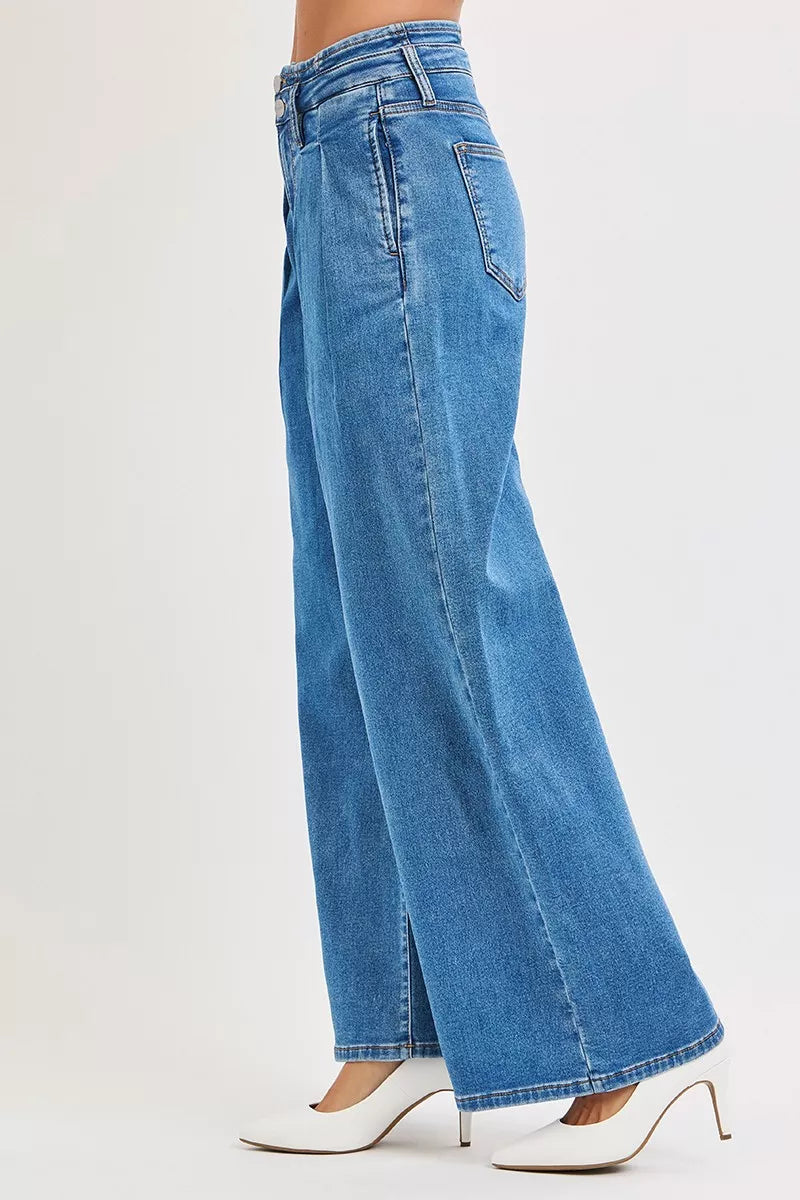 Blue jeans worn by a person on a white background