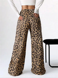 Leopard print pants worn by a person on a white background