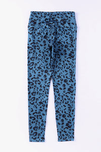 Blue leggings with black leopard print on a white background