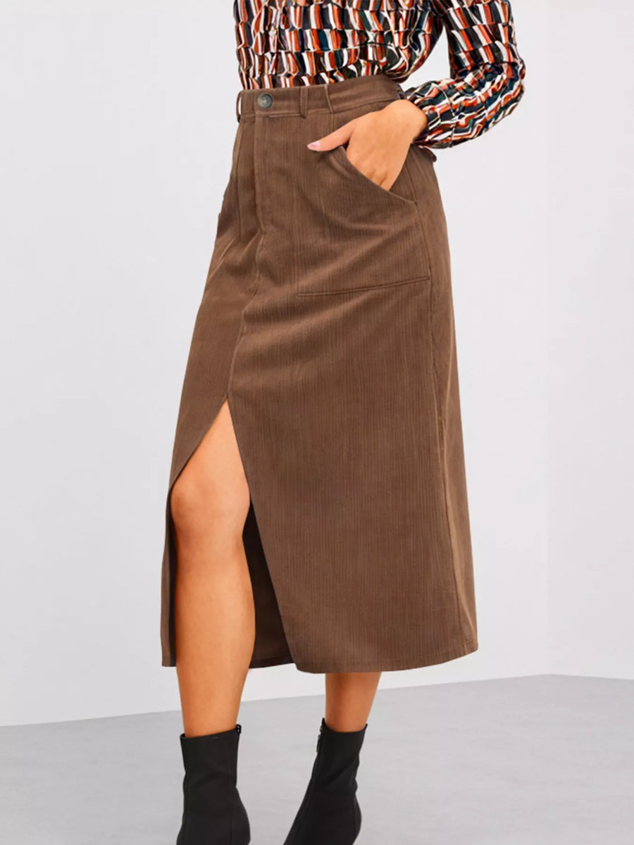 Brown corduroy skirt worn by a person on a plain background