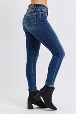 Blue jeans worn by a person on a white background