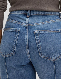 Close-up of blue jeans with a neutral background