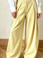 Light yellow wide-leg pants worn by a person on a neutral background