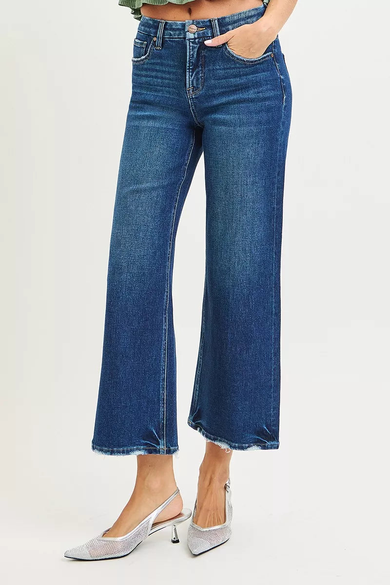 Blue jeans worn by a person on a light gray background