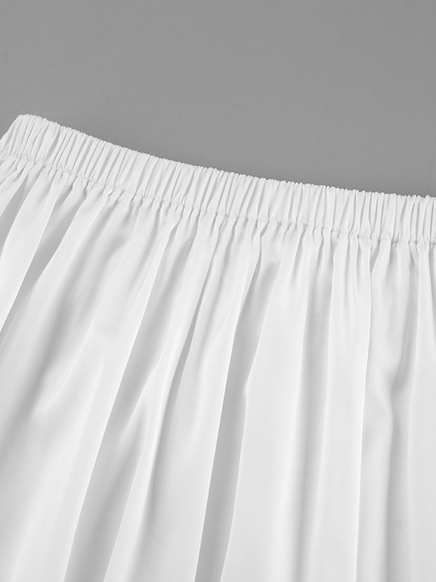 Close-up of a white skirt with a gray background