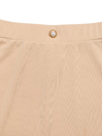 Close-up of beige fabric with a pearl button detail