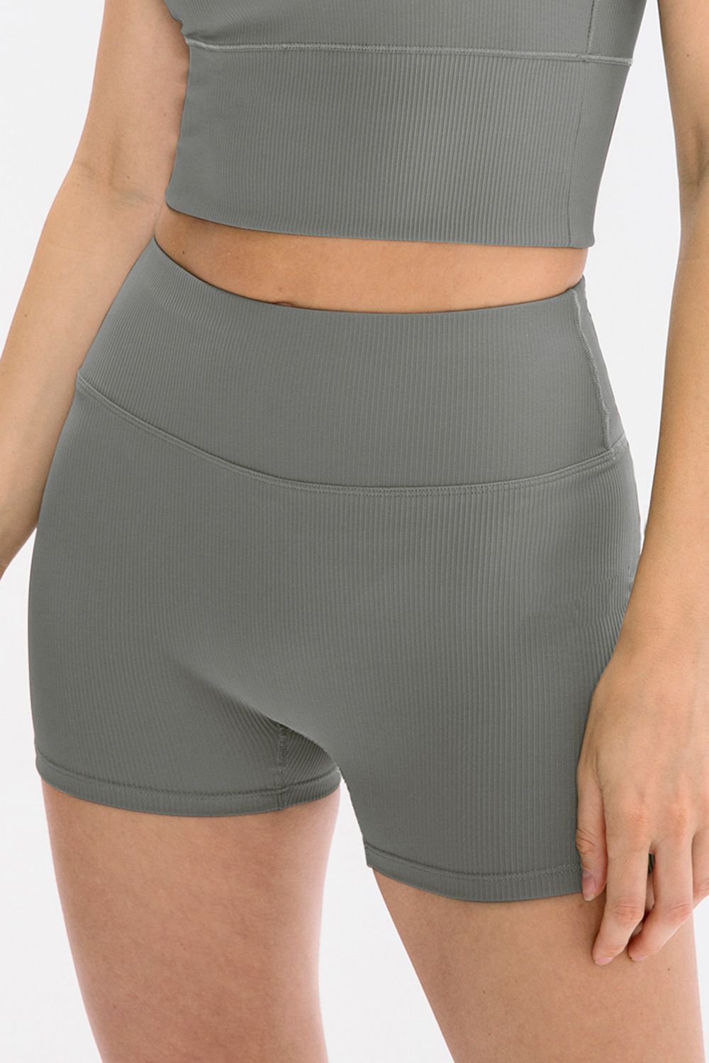 Gray athletic shorts worn by a person on a white background